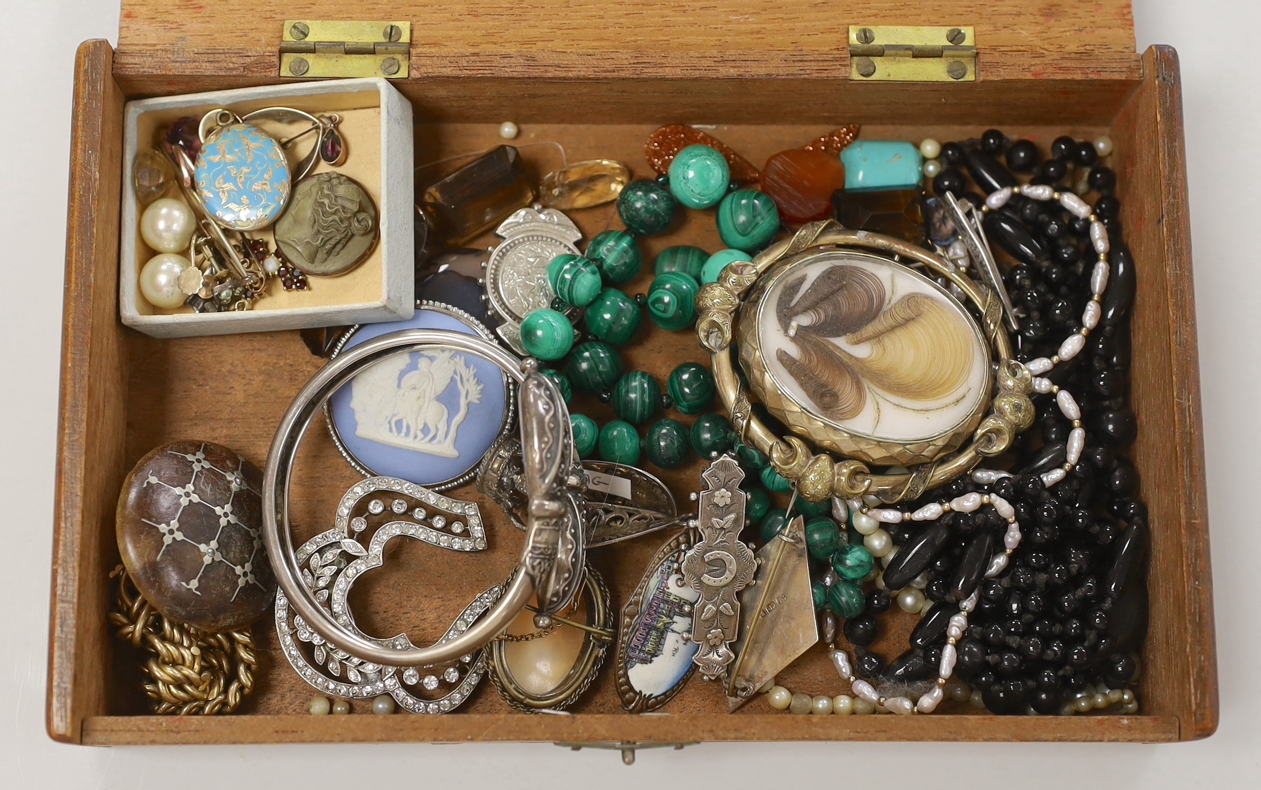 A small group of assorted mainly late 19th century jewellery, including two silver brooches, mourning brooch, malachite necklace, 800 bangle, paste set brooches, 9ct and gem set pendant, enamelled mourning locket, lave b